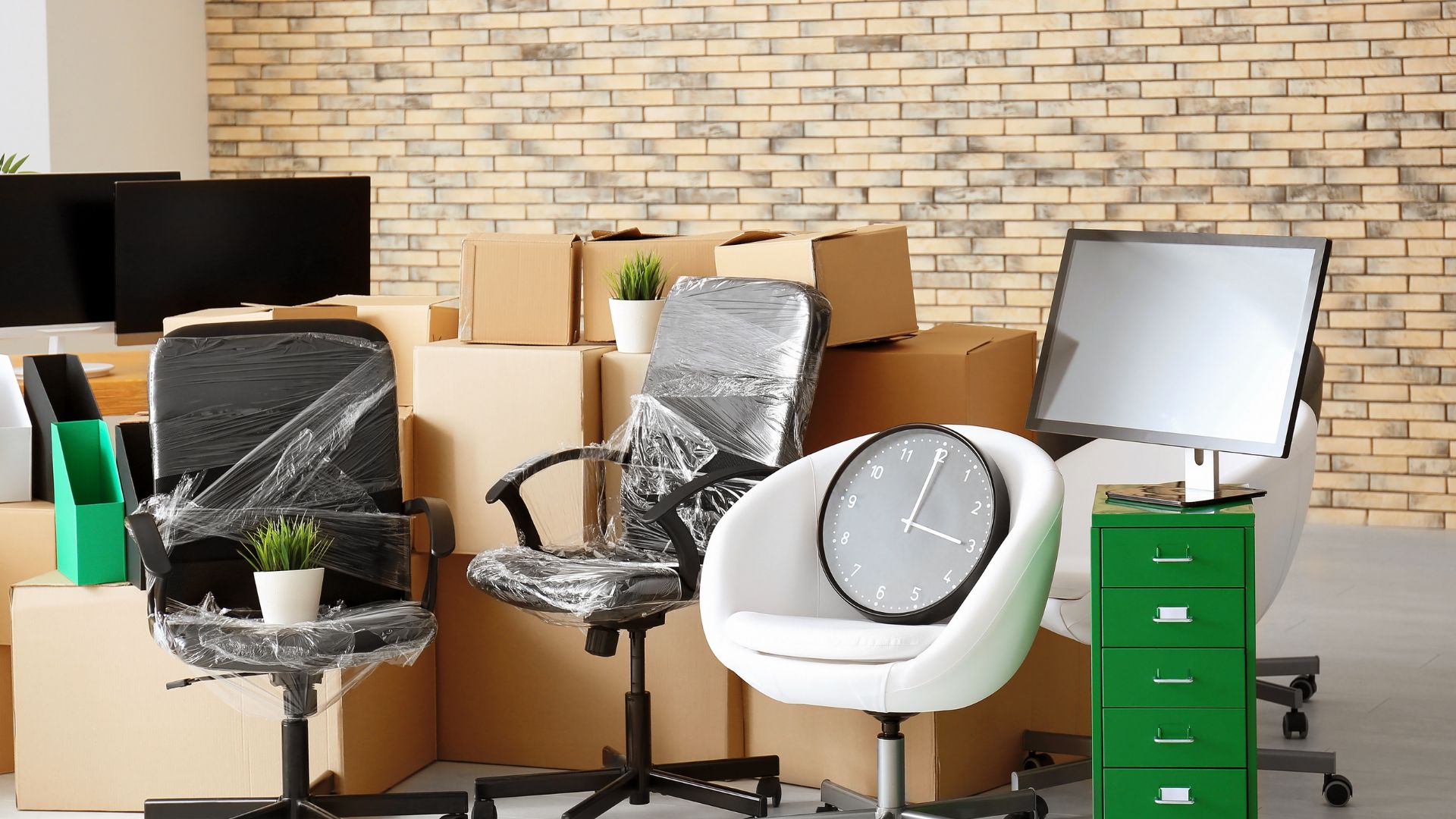 A pile of boxes and chairs with a clock on them