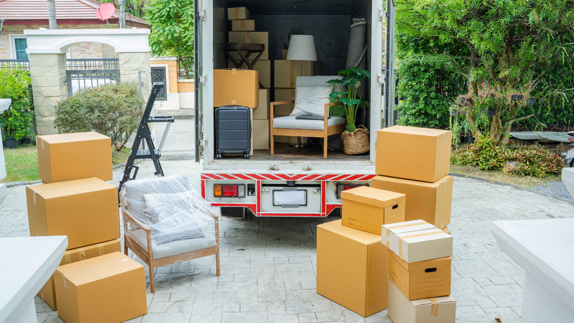 A moving truck is loaded with boxes and furniture